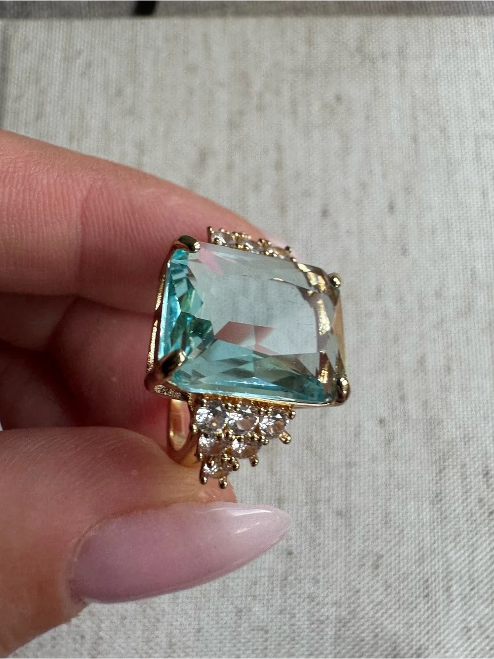Stunning gold tone ring with blue crystal
